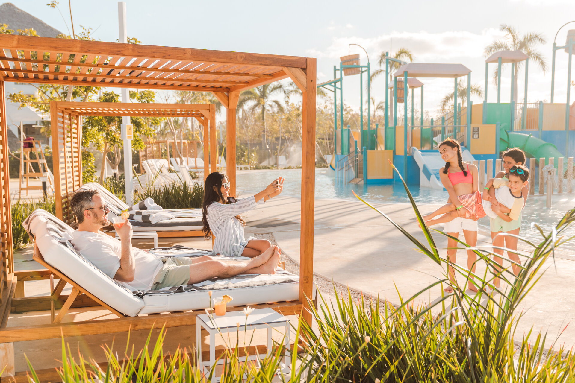 family spending time by splash pad